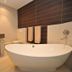 Apollo Hotel Johannesburg bathroom with freestanding tub, vanity sink and wall-mounted towels