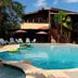 Hacienda el Jibarito in San Sebastián with an outdoor pool, lounge chairs, and palm trees