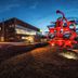 Parkhotel Luise in Bad Herrenalb exterior at dusk with illuminated modern building and red sculpture