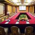 Hangzhou Blossom Water Museum Hotel meeting room in Hangzhou with U-shaped conference table and projector screen