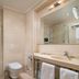 Mercure Chisinau Center Jazz Hotel bathroom with glass shower, wall-mounted toilet and vanity in Chisinau