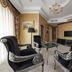 Boutique Hotel Buta in Minsk, elegant lounge with black velvet chairs, glass table and chandelier
