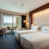 Delta Hotels by Marriott Olbia Sardinia guest room with twin beds, desk and balcony view in Olbia