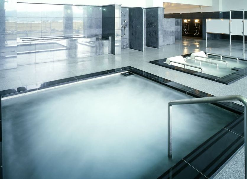 Spa&hotel Resort Furano La Terre indoor spa pool with steam and metal handrails in Nakafurano