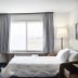 Fairfield Inn & Suites by Marriott Sheboygan guest room with bed, desk, chair and large window