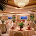 Courtyard by Marriott Los Angeles Sherman Oaks banquet room with round tables, floral centerpieces, and chandeliers