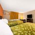 Express Inn & Suites San Antonio Near Sea World Medical Center room with two beds, TV and round mirror