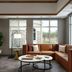 Inn at Bellefield in Hyde Park lounge with sectional sofa, coffee table, and large windows