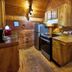 A Cabin In The Woods kitchen in Pigeon Forge with wood interiors, stainless appliances, and a dining nook