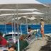 Tymnos Hotel in Bozburun with sun loungers and parasols on a seaside deck by the water