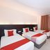 Kenyalang Suite Miri guest room with three single beds and red accents