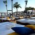 Presidential Suites by Lifestyle in Puerto Plata beachside cabanas with lounge chairs, palm trees, and ocean view
