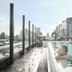 The Steam Hotel, Västerås rooftop pool with guests and city views beside glass facade