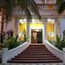 Mansion Giahn Bed & Breakfast in Cancún, palm-lined entrance with grand staircase and columns