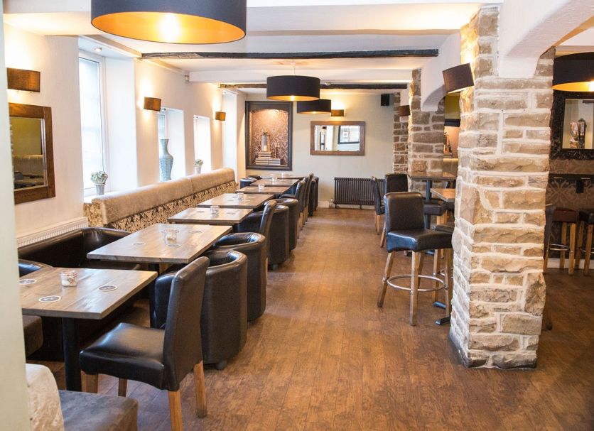 The Manor House Hotel in Dronfield restaurant with stone pillars, leather seating and bar stools