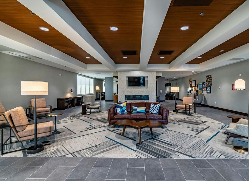 Four Points by Sheraton Brunswick lobby lounge with seating, fireplace, and wood ceiling accents