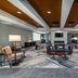 Four Points by Sheraton Brunswick lobby lounge with seating, fireplace, and wood ceiling accents