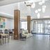 Hilton Garden Inn Clifton Park lobby with seating area and glass entrance doors