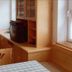 Borcanela Apartments in Moena: cozy apartment room with TV on wood cabinet and dining table