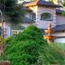 Bella Vista Bed and Breakfast in Placerville with landscaped gardens, wrought-iron arch, and fountain