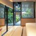 Ignacia Guest House, Mexico City guest room with open glass doors to a garden courtyard