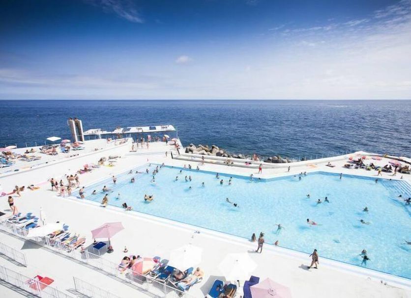 Terrace Mar Suite Hotel in Funchal with a large oceanfront pool and sun loungers by the sea