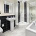 Hawksmoor Guest House Windermere bathroom with glass shower, soaking tub, and pedestal sink