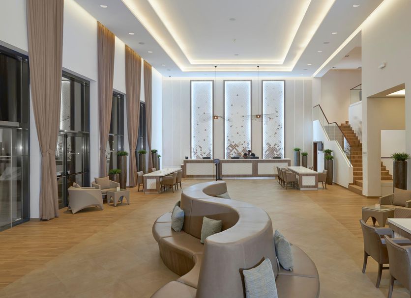 Meliá Llana Beach Resort & Spa in Santa Maria lobby with curved seating and tall windows