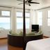 Bravo Beach Hotel in Vieques with ocean-view room, round daybed, and bed by large windows