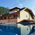 Dorf.Apart in Neustift im Stubaital with mountain views and an outdoor pool reflecting the building