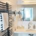 Zunfthaus zu Wirthen bathroom in Solothurn with mirror, sink, towel radiator and wall lights