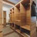 Der Gollinger in Hinterglemm: wood-paneled room with open wardrobe, bed, and large window with curtains