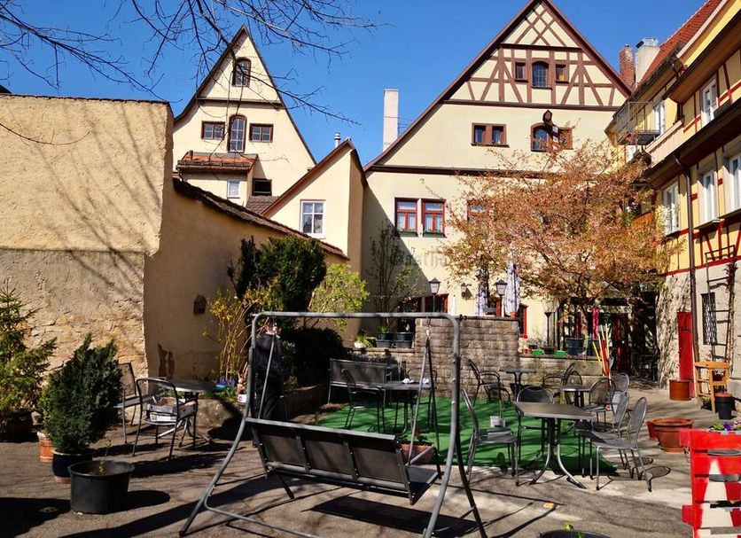 Hotel-Gasthof Goldener Greifen courtyard in Rothenburg ob der Tauber with outdoor seating and historic buildings