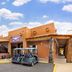 Best Western East Zion Thunderbird Lodge in Mount Carmel with rustic exterior and golf carts parked outside