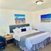 Blue Sage Inn & Suites in Blanding guest room with king bed, nightstands, and framed landscape art