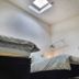 Deepcut Lodge Bed & Breakfast Self Service in Camberley: attic room with two beds, skylight and TV