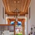 Panamare Apart Hotel Akyaka lobby corridor with carved wooden ceiling and view to the courtyard