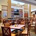 Hilton Garden Inn Milwaukee Northwest Conference Center restaurant with tables, chairs and bar area in Milwaukee