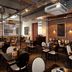 Premier Inn Birmingham City - Waterloo St restaurant with tables, chairs and brick wall decor
