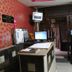 Yes Please Guest House, New Delhi reception area with front desk, computer, TV, and beverage cooler