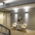 Luna Boutique Hotel Antalya hallway with staircase, lit wall sconces, and small seating area with flowers