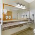 Best Western Gold Canyon Inn & Suites bathroom with granite counter, mirror, sink and toilet in Gold Canyon