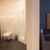 Hotel Bieze Borger bathroom and bedroom with walk-in shower and upholstered chair