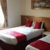 Ashbourne House Hotel in Ashbourne guest room with two single beds and red accents