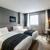 Hotel28 Myeongdong Seoul guest room with two twin beds, desk, and city window view