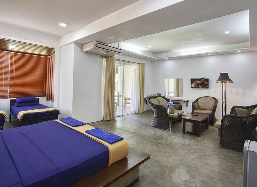 Athena Lake by Seedevi in Sigiriya: spacious hotel room with twin beds, seating area, and balcony doors