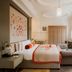 The Lalit London, London guest room with bed, sofa, TV and large windows