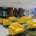 Wyndham Anaheim Hotel lobby with yellow armchairs, check-in desk and brochure rack in Anaheim