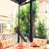 Taks-Inn Suites Istanbul balcony with outdoor dining table and leafy city view
