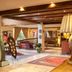 Le Manoir de Gressy in Gressy lobby with exposed beams, patterned rugs, and upholstered seating